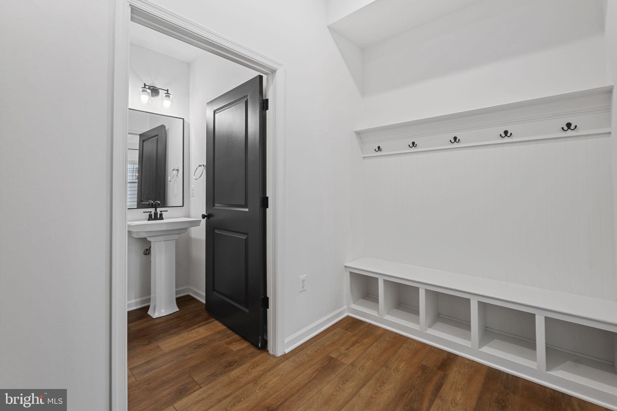 18080 Moss Garden Road Dumfries, VA 22026 - Photo 20 of 76 a view of a hallway with wooden floor and a bathroom