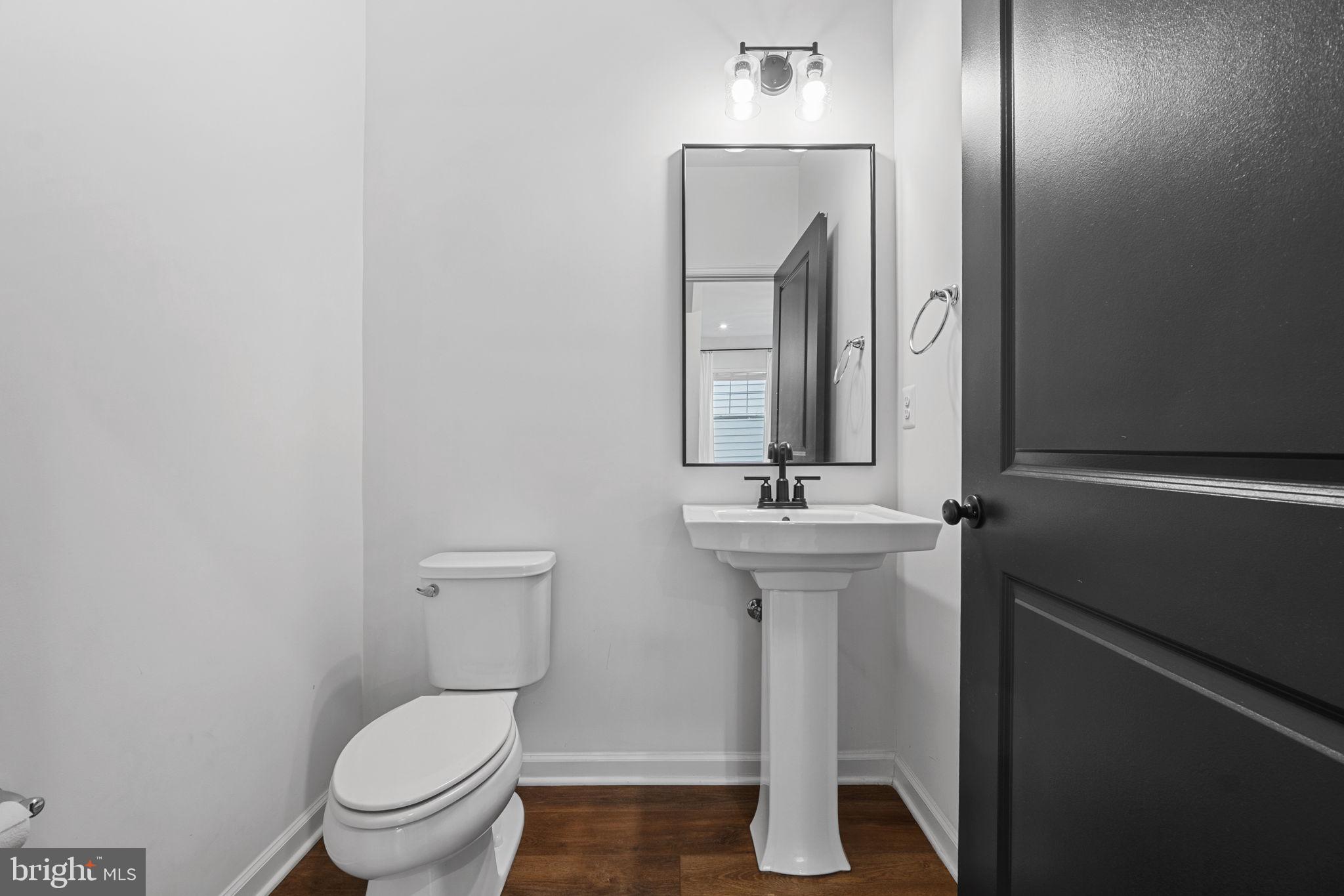 18080 Moss Garden Road Dumfries, VA 22026 - Photo 21 of 76 a bathroom with a toilet sink and mirror