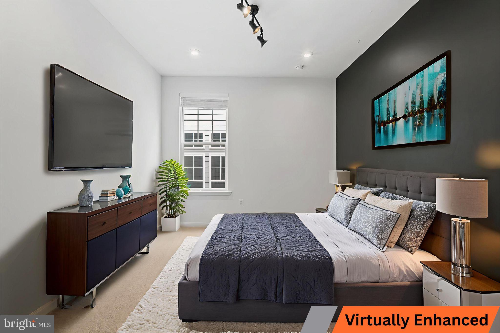 18080 Moss Garden Road Dumfries, VA 22026 - Photo 30 of 76 a bedroom with a bed and a flat screen television