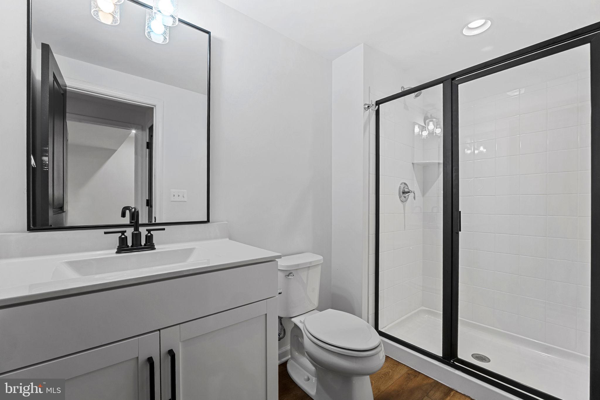 18080 Moss Garden Road Dumfries, VA 22026 - Photo 45 of 76 a bathroom with a toilet a sink and mirror