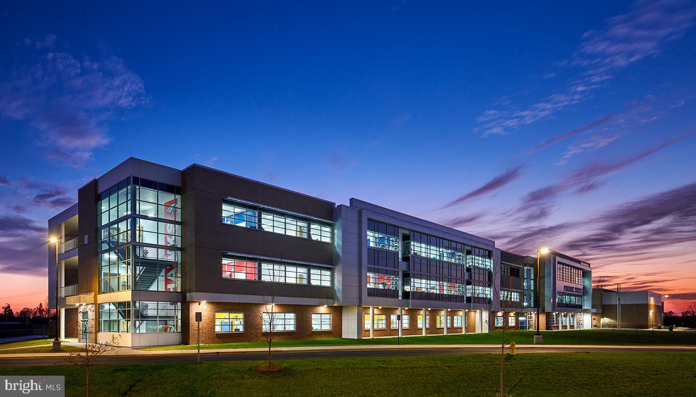 18080 Moss Garden Road Dumfries, VA 22026 - Photo 70 of 76 a front view of a building with lake view and a floor to ceiling window