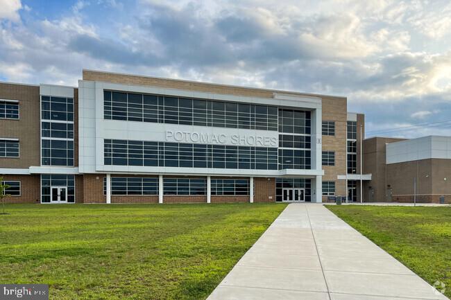 18080 Moss Garden Road Dumfries, VA 22026 - Photo 71 of 76 a front view of a building with a yard