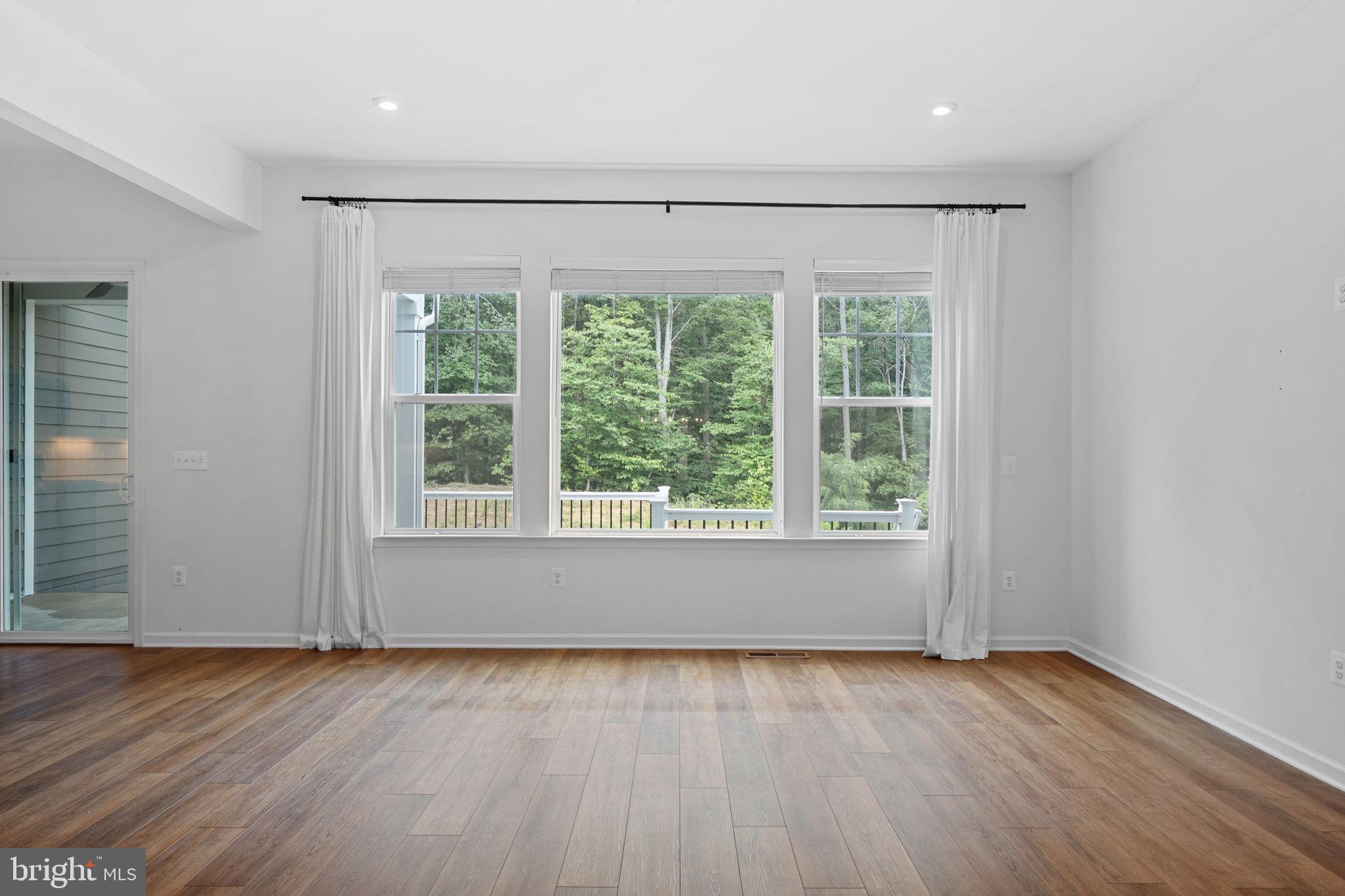 18080 Moss Garden Road Dumfries, VA 22026 - Photo 9 of 76 an empty room with wooden floor and windows
