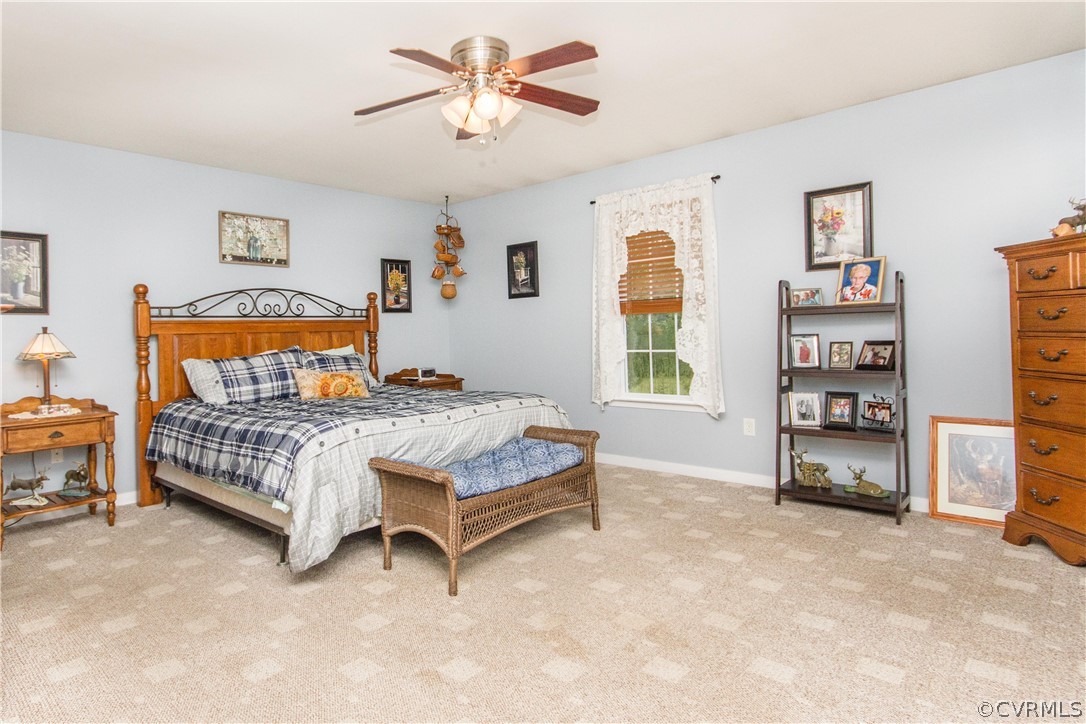19725 Carson Ruritan Road Carson, VA 23830 - Photo 14 of 36 a bedroom with a bed and a walk in closet
