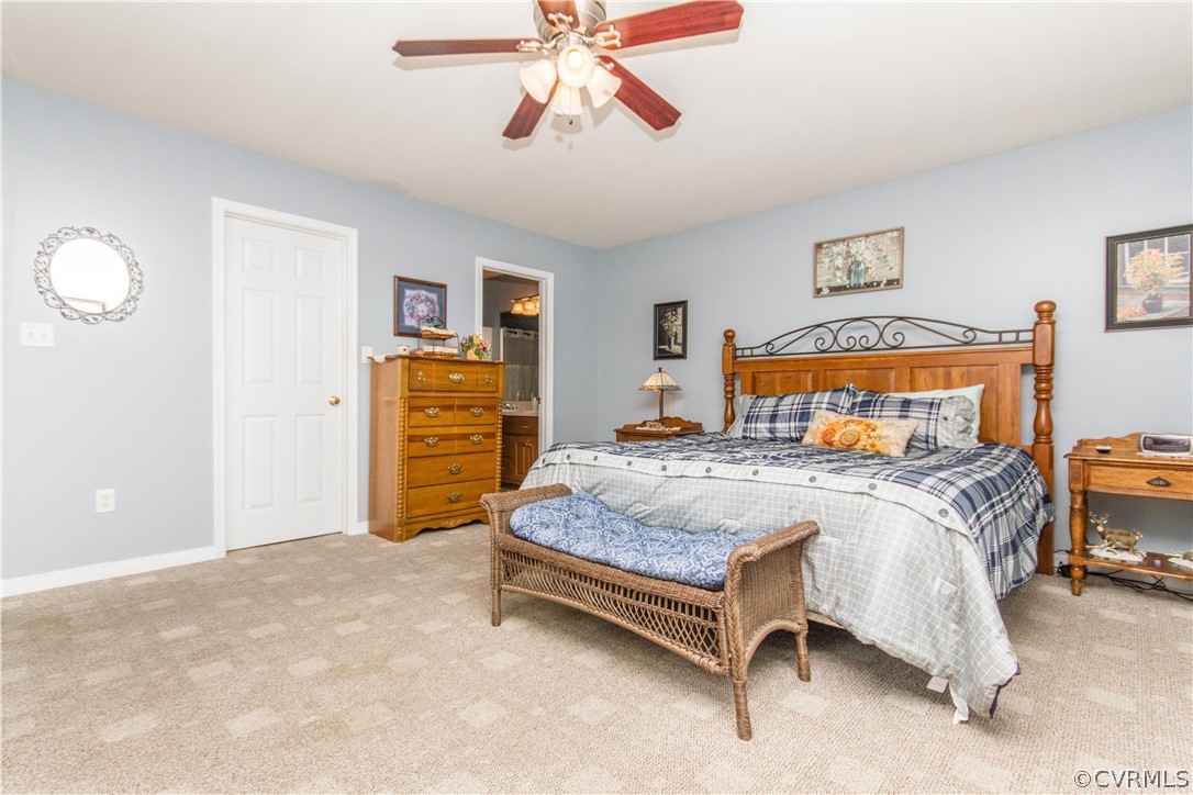 19725 Carson Ruritan Road Carson, VA 23830 - Photo 15 of 36 a bedroom with a bed and a chandelier