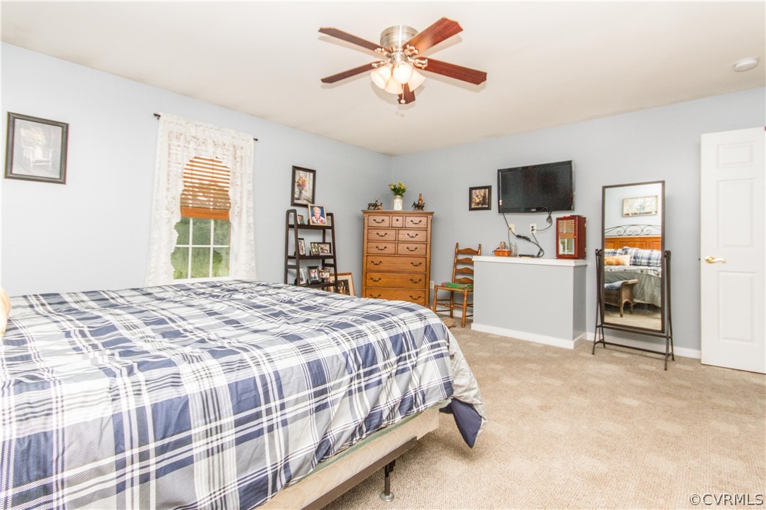 19725 Carson Ruritan Road Carson, VA 23830 - Photo 16 of 36 a bedroom with a bed and a television