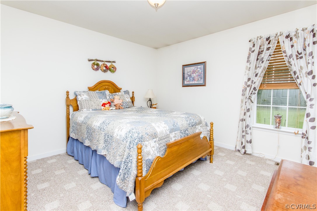 19725 Carson Ruritan Road Carson, VA 23830 - Photo 18 of 36 a bedroom with a bed and a window