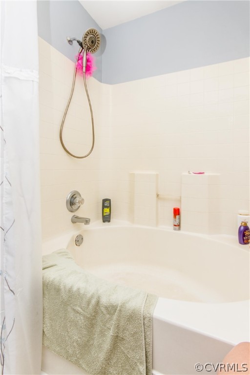 19725 Carson Ruritan Road Carson, VA 23830 - Photo 25 of 36 a bathroom with a bath tub a sink and a chandelier