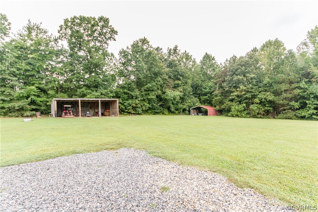 19725 Carson Ruritan Road Carson, VA 23830 - Photo 34 of 36 a view of a house with a yard and a trees
