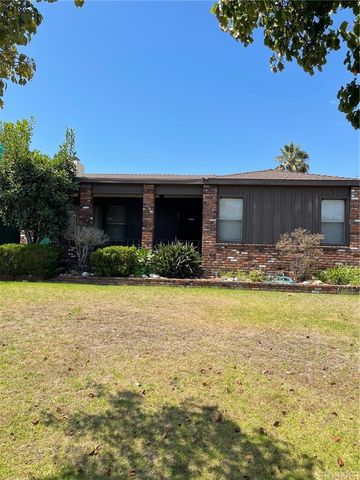 a front view of house with yard and swimming pool