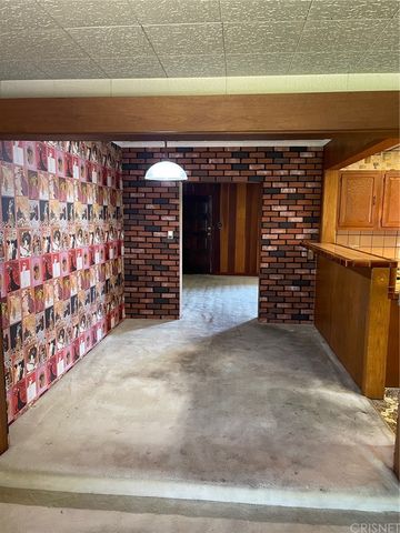 a view of empty room with window and fireplace