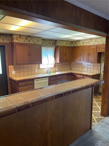 a kitchen with stainless steel appliances a sink and a window