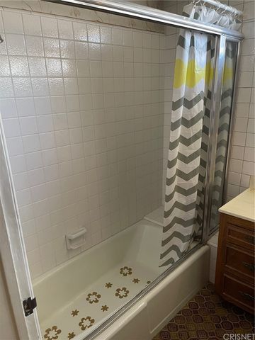 a bathroom with a shower and a bathtub