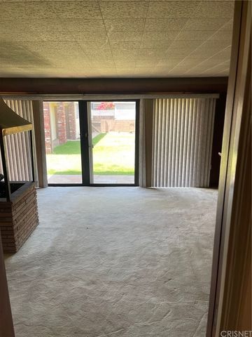 a view of an empty room and a window