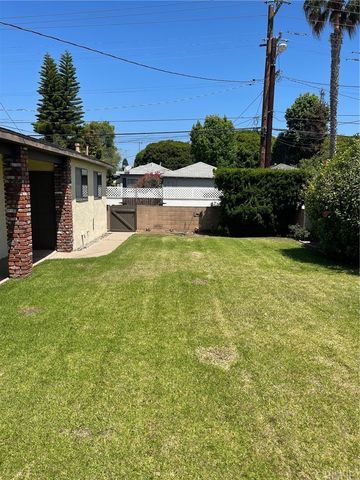 a view of a house with pool and a yard