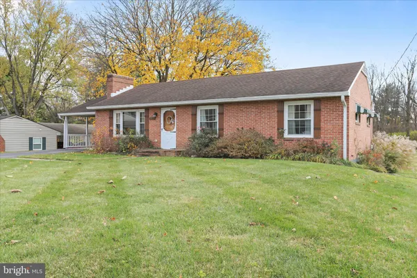 a front view of house with yard and green space