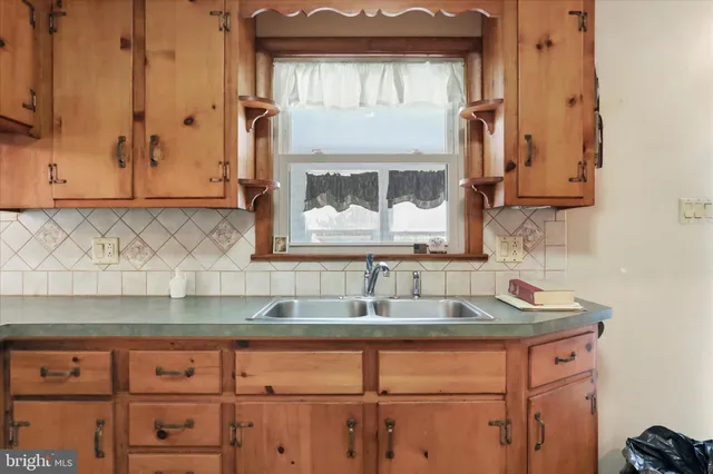 a kitchen with granite countertop a sink and cabinets