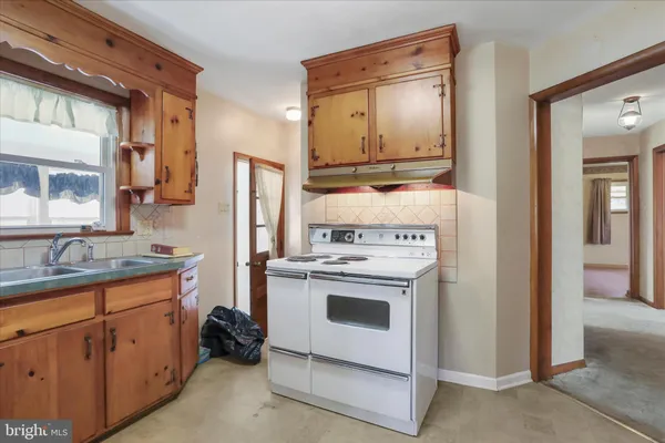 a kitchen with a stove sink and refrigerator