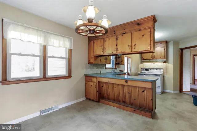 a kitchen with stainless steel appliances granite countertop a sink and cabinets