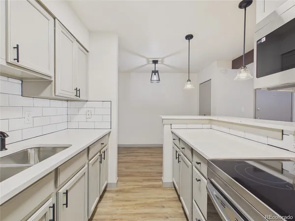 a kitchen with a sink and a stove top oven