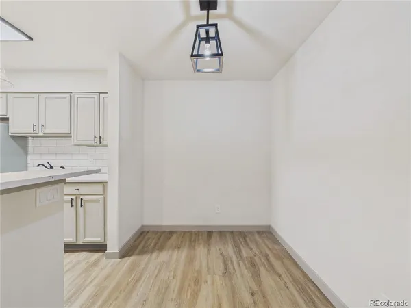 a view of kitchen with wooden floor and electronic appliances