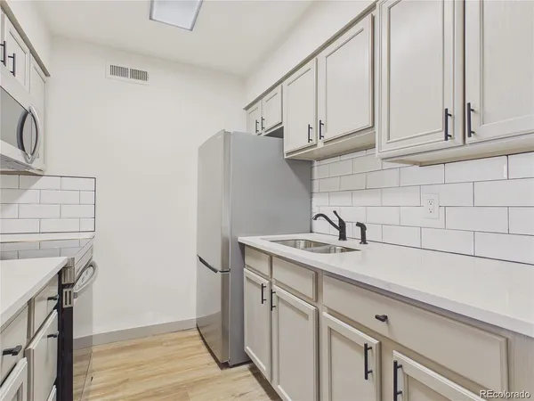 a kitchen with a sink and cabinets