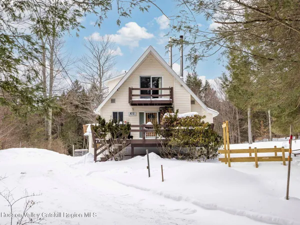 a view of a house with a snow in the yard