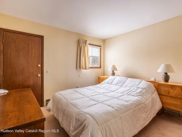 a bedroom with a bed and lamp