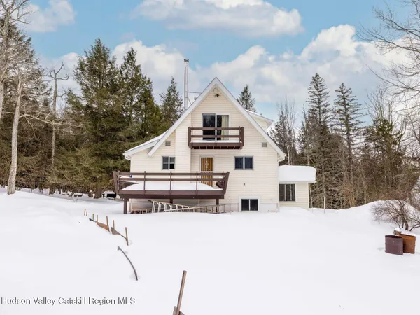a view of a house with a snow in the background