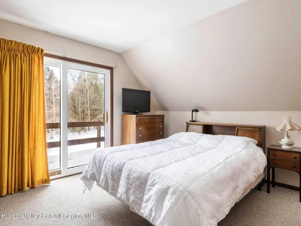 a bedroom with a bed and cabinet