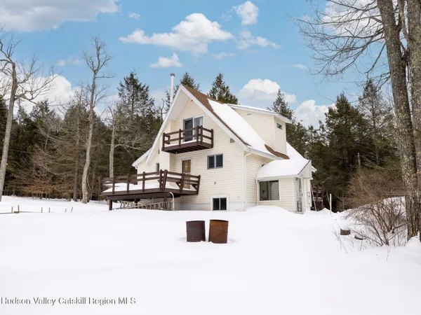 a view of a house with a snow in the yard