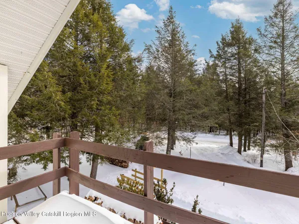 a view of a house with snow on the road