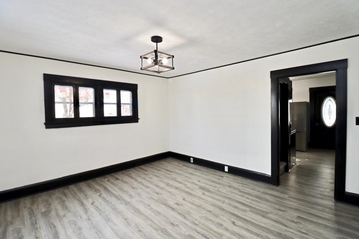 15738 Farm School Road Durand, IL 61024 - Photo 6 of 20 a view of empty room with wooden floor and fan
