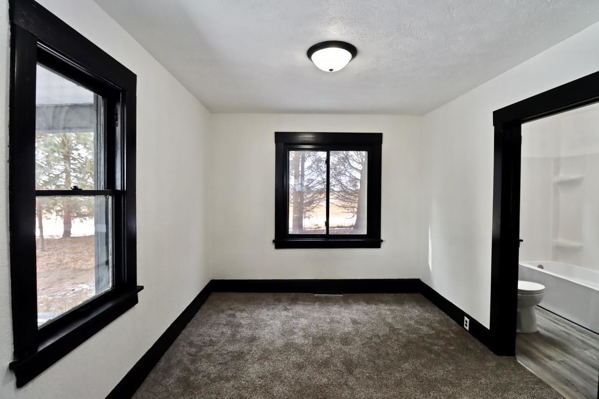 15738 Farm School Road Durand, IL 61024 - Photo 8 of 20 a view of an empty room with window and mirror