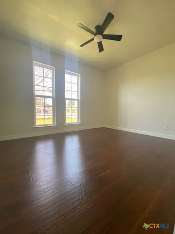 a front view of house with yard and trees