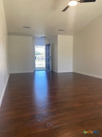 a view of a kitchen with a sink and a refrigerator