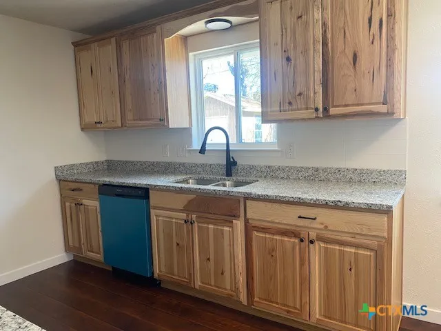 a view of a big room with wooden floor and windows