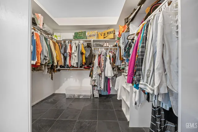 a view of walk in closet with clothes