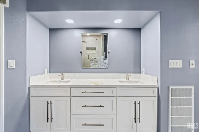 a bathroom with a double vanity sink mirror and