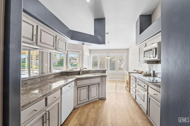 a large kitchen with granite countertop a lot of counter space