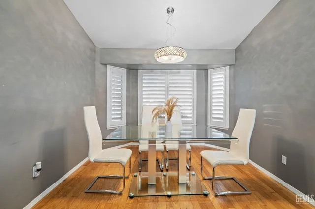 a view of a kitchen with a table and a chair
