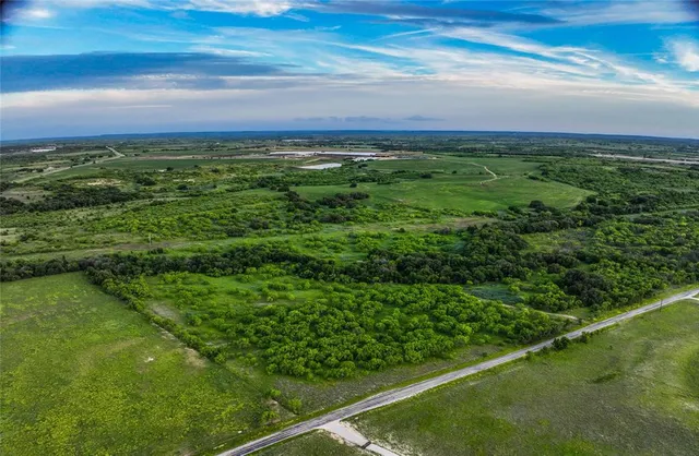 a view of a field with an ocean view