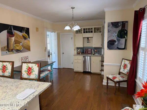 a kitchen with a sink cabinets stainless steel appliances and a window