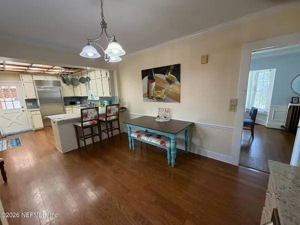 a view of a dining room with furniture window and wooden floor