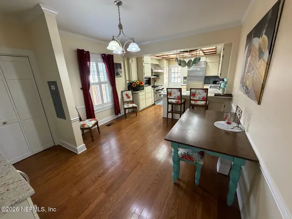 a view of a dining room with furniture and wooden floor