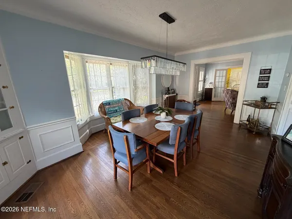 a living room with fireplace furniture and a wooden floor