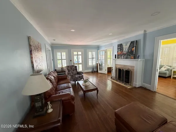 a living room with furniture and a wooden floor