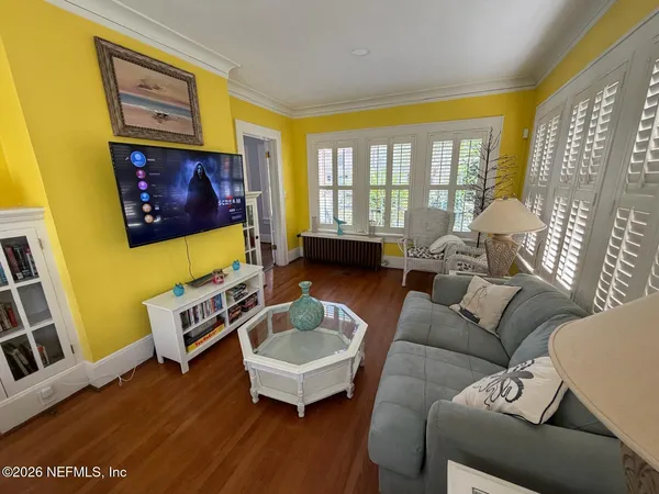 a living room with furniture and a flat screen tv