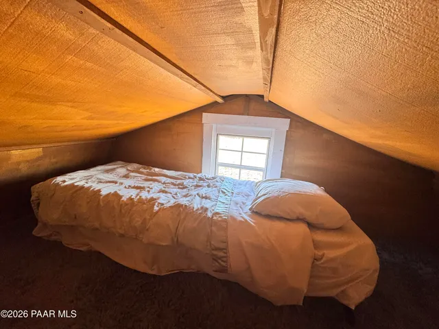 a bedroom with a bed and window