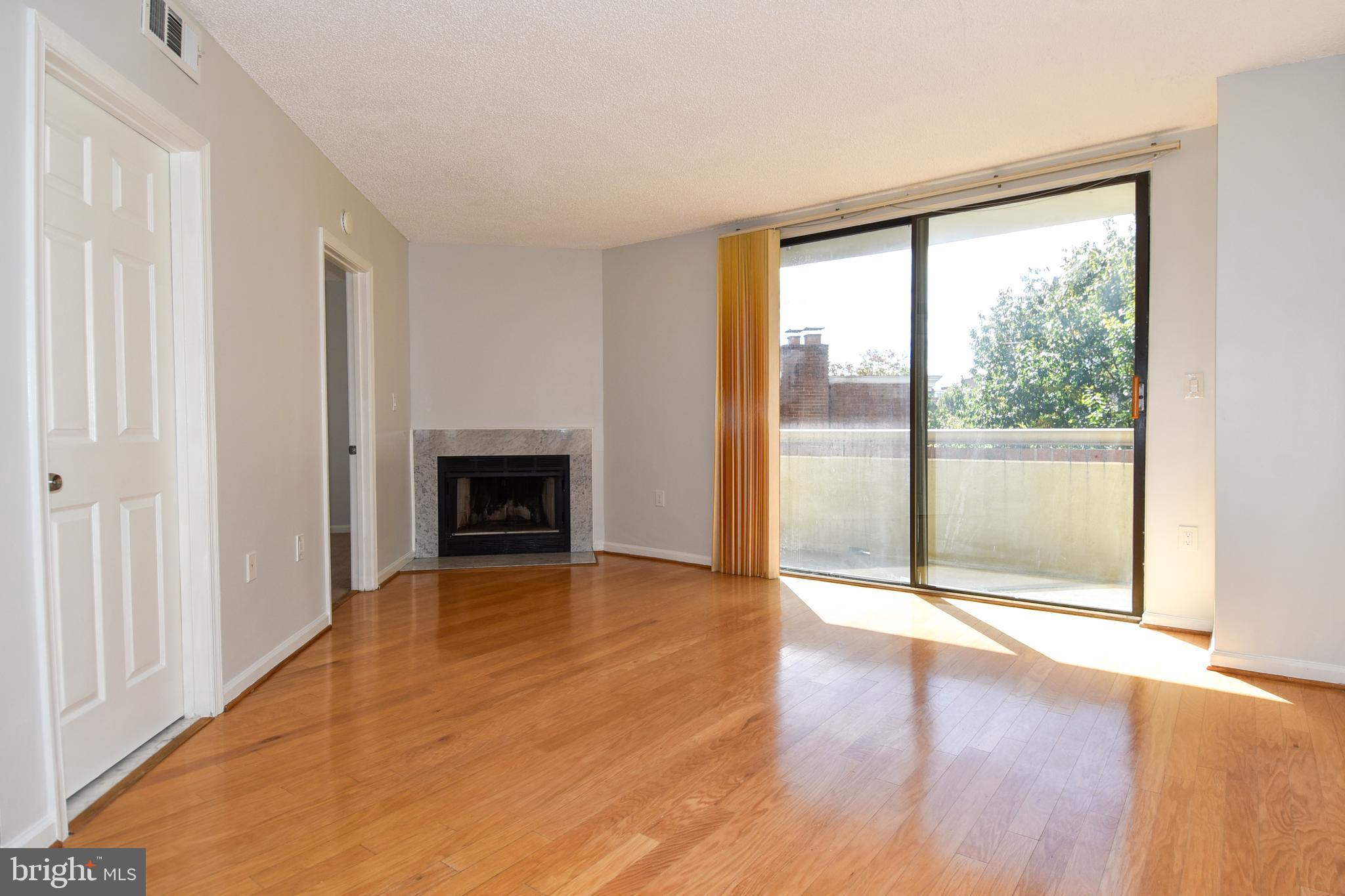 2725 Connecticut Avenue Northwest, Unit 403 Washington, DC 20008 - Photo 1 of 25 a view of an empty room with wooden floor and a window